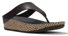 Load image into Gallery viewer, A single black wedge thong sandal with a woven beige and black herringbone-patterned sole, shown from a side profile on a white background.
